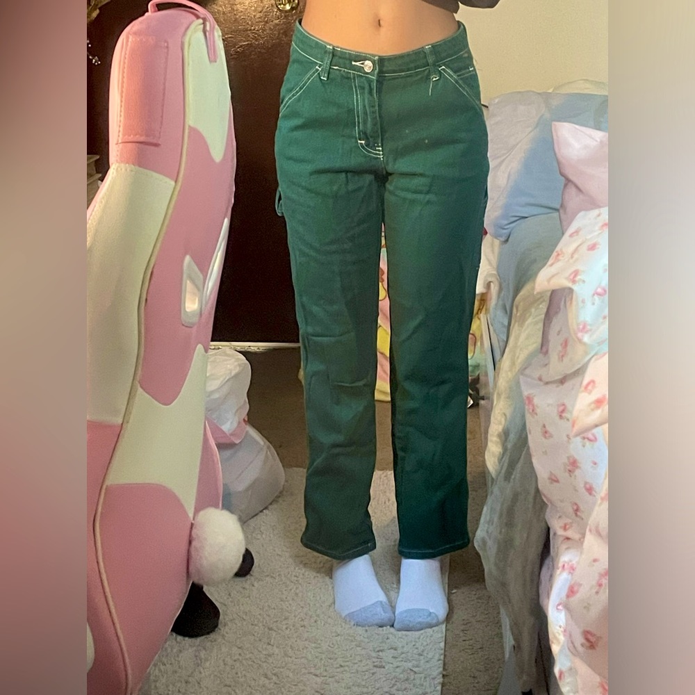 Green jeans with White stitching.